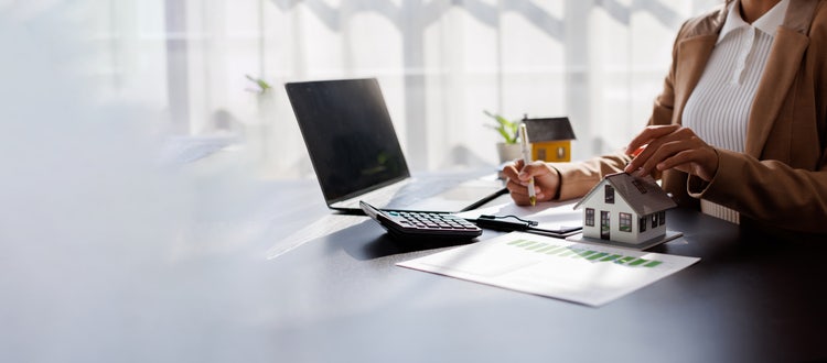 real estate agent manager working on calculator and documents, mortgage and property.